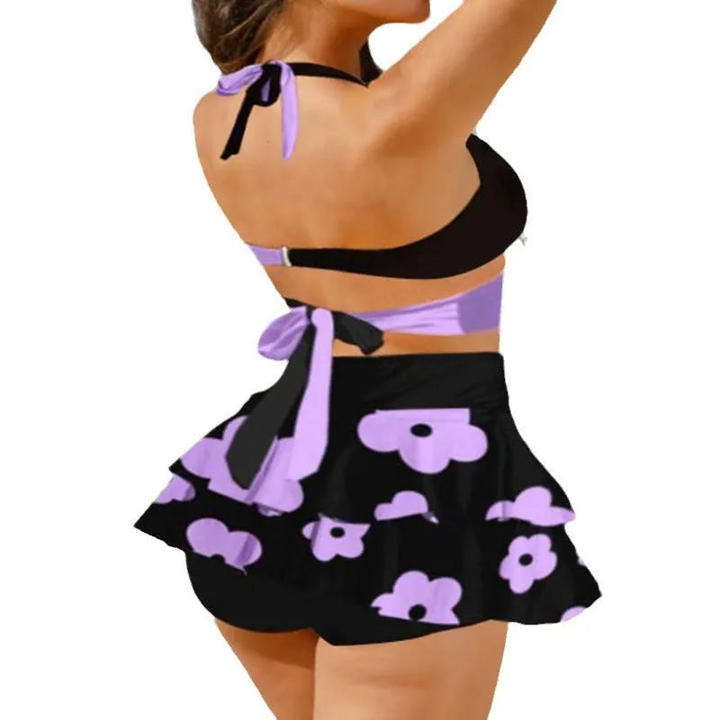 Purple women's bikini set showing lace-up backless top and high-waist briefs with a split skirt.