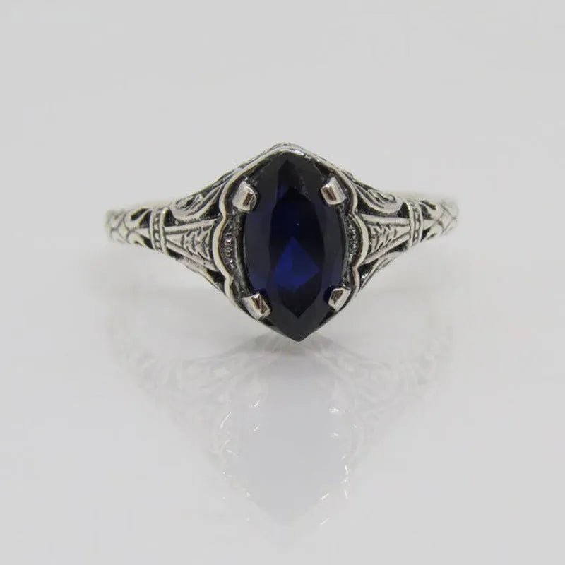 Silver alloy geometric hollow ring with zircon stone on white background, women's ring size 7