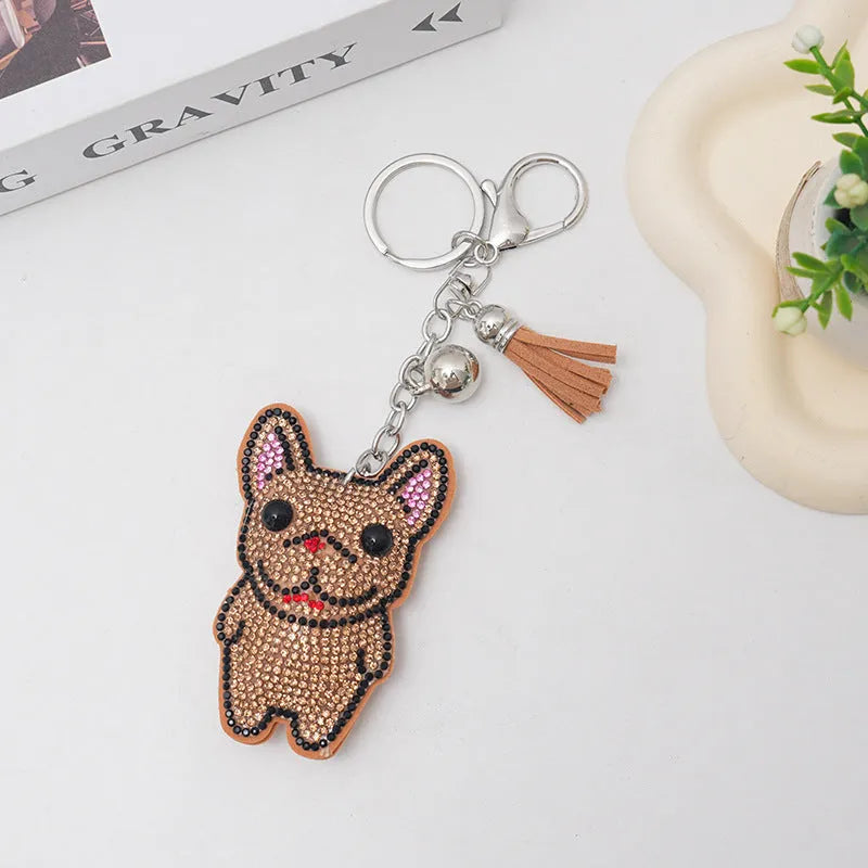 Close-up of a sparkling rhinestone French dog animal keychain charm in caramel colour.