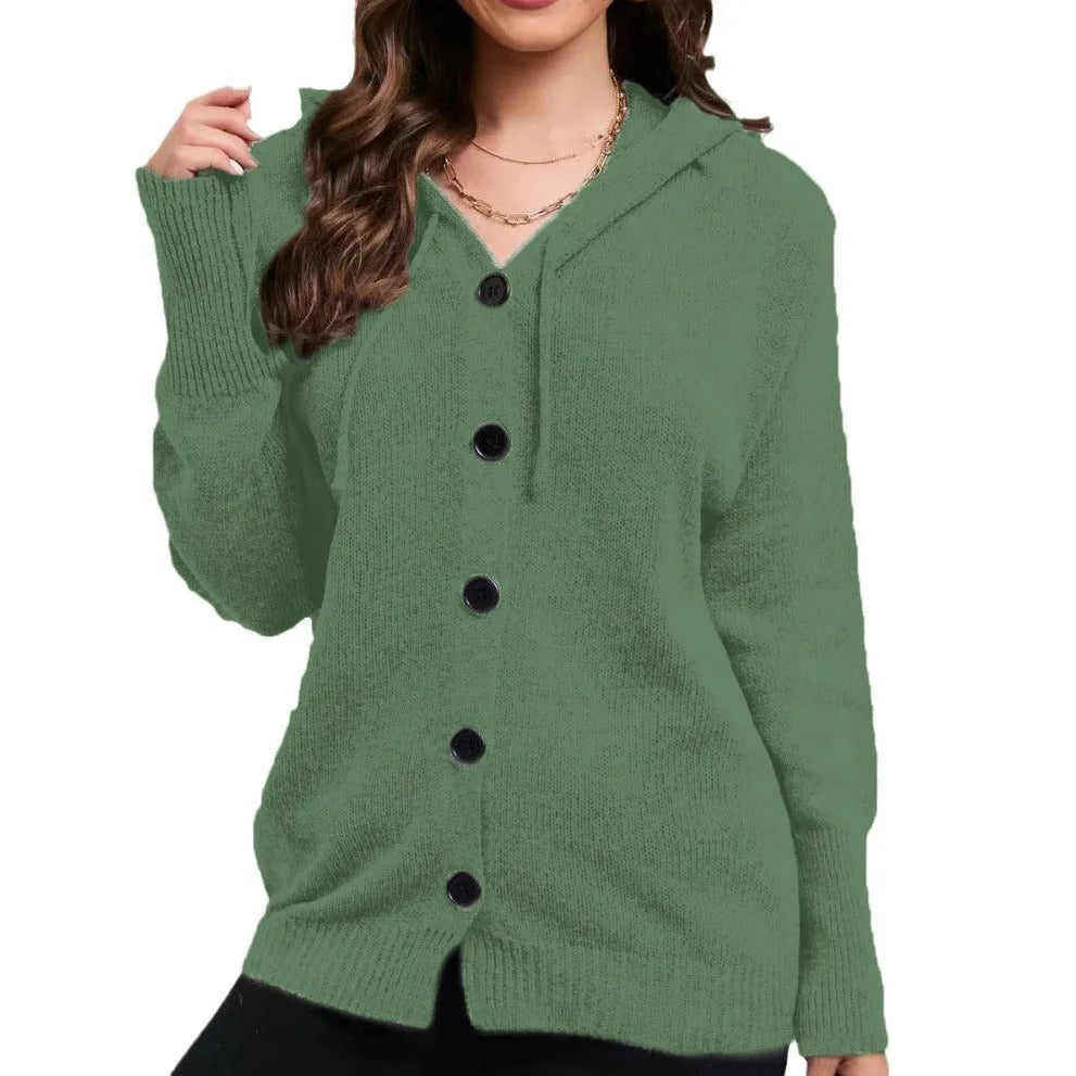 Woman wearing a thick, loose-fit hooded cardigan sweater in a solid colour.
