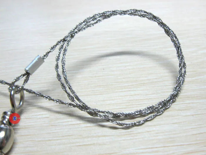 Stainless steel survival wire saw with thumb rings showing 55cm blade and compact storage size
