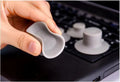 Four grey plastic non-slip laptop cooling pads, two large and two small, on a desk.