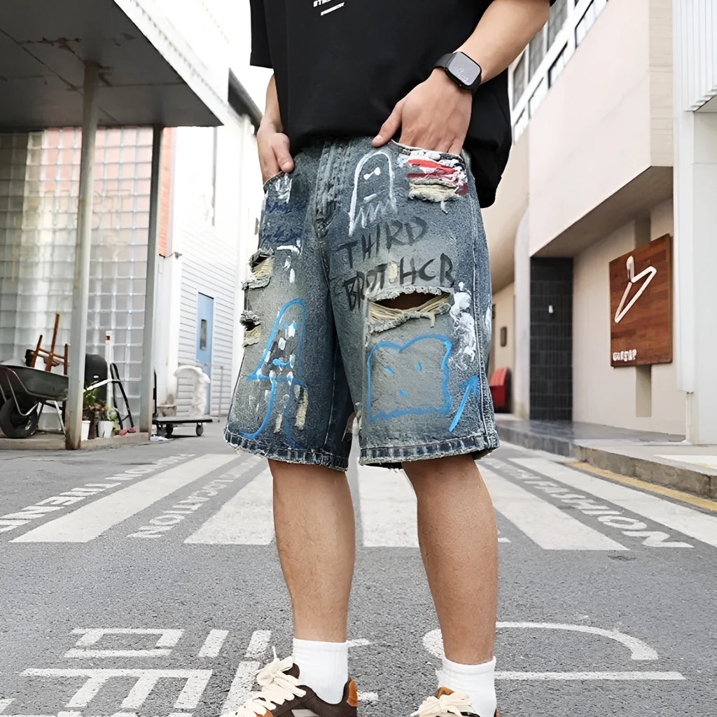 Blue denim shorts for men with ripped detailing and a straight leg cut.
