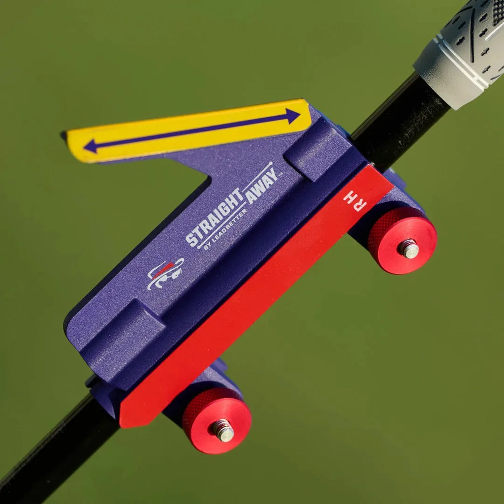 Plastic golf swing plane training aid simulator on a green background.