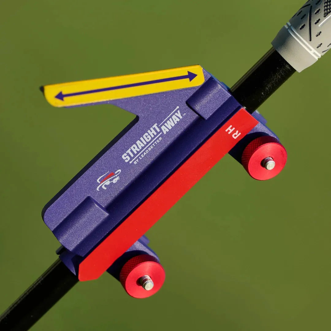 Plastic golf swing plane training aid simulator on a green background.