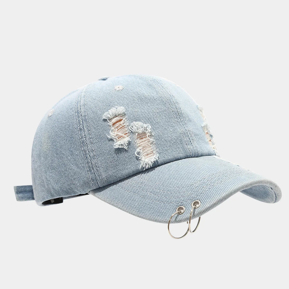 Men's adjustable denim peaked cap with dome crown in light blue jeans colour on a plain background