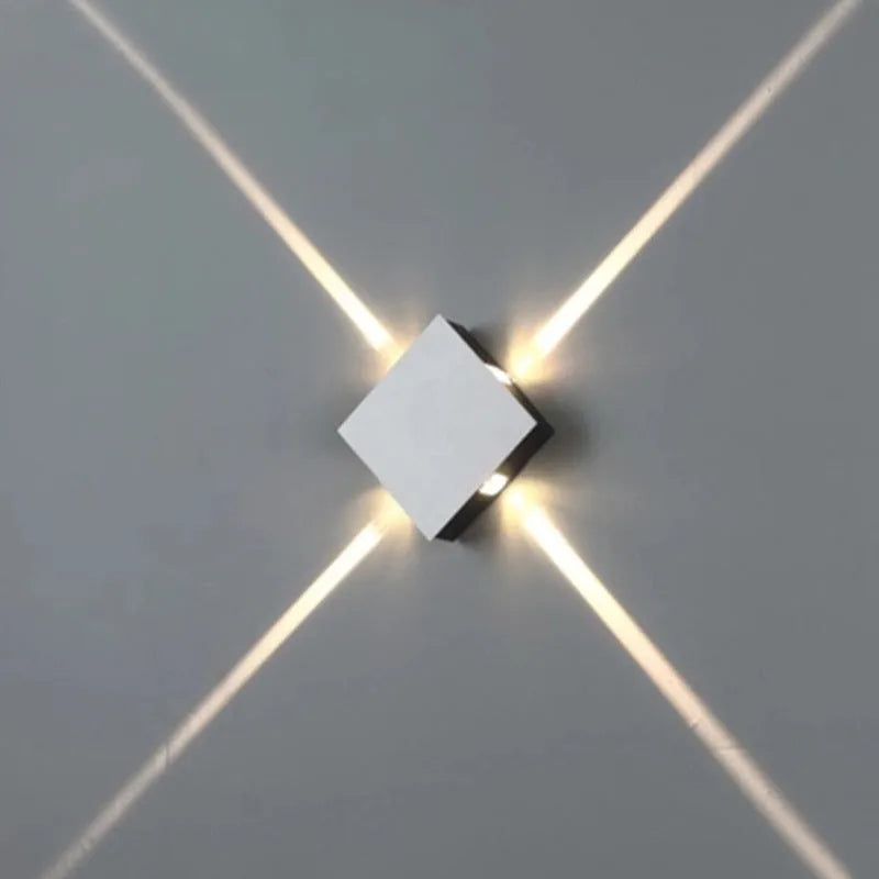 Modern square aluminium and iron LED wall light with warm white glow on a wall
