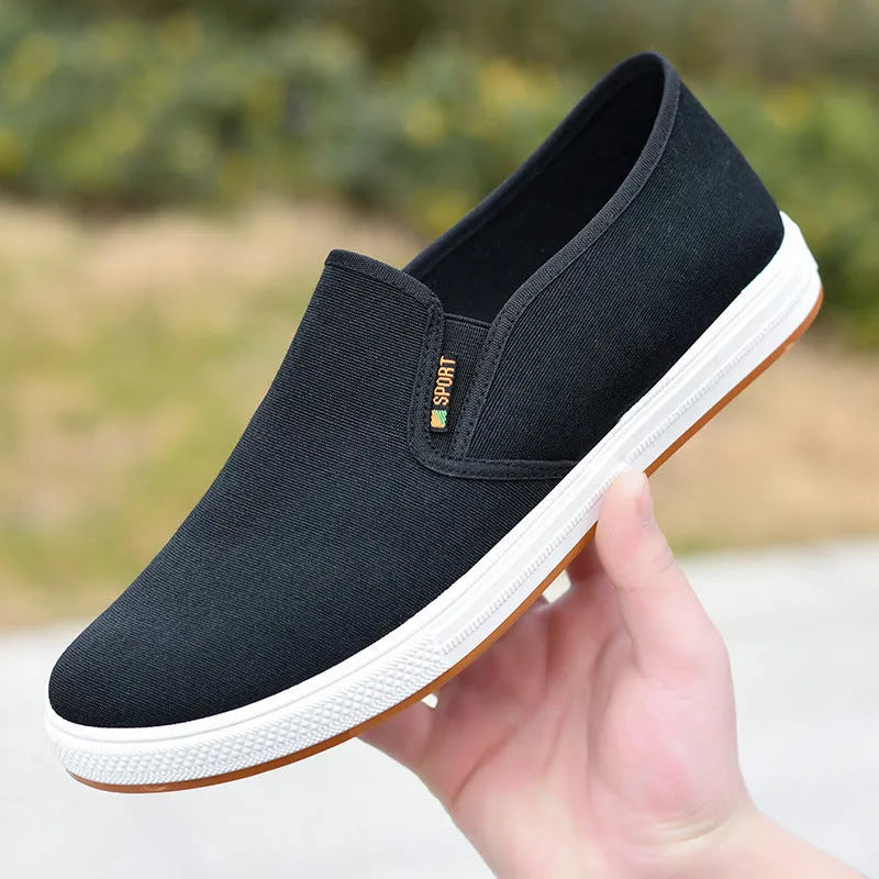 Men's low-top canvas slip-on shoes in blue colour showing round-toe design and composite soles