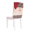 Christmas chair set with Santa Claus and Snowman covers and red Santa hat on standard dining chairs