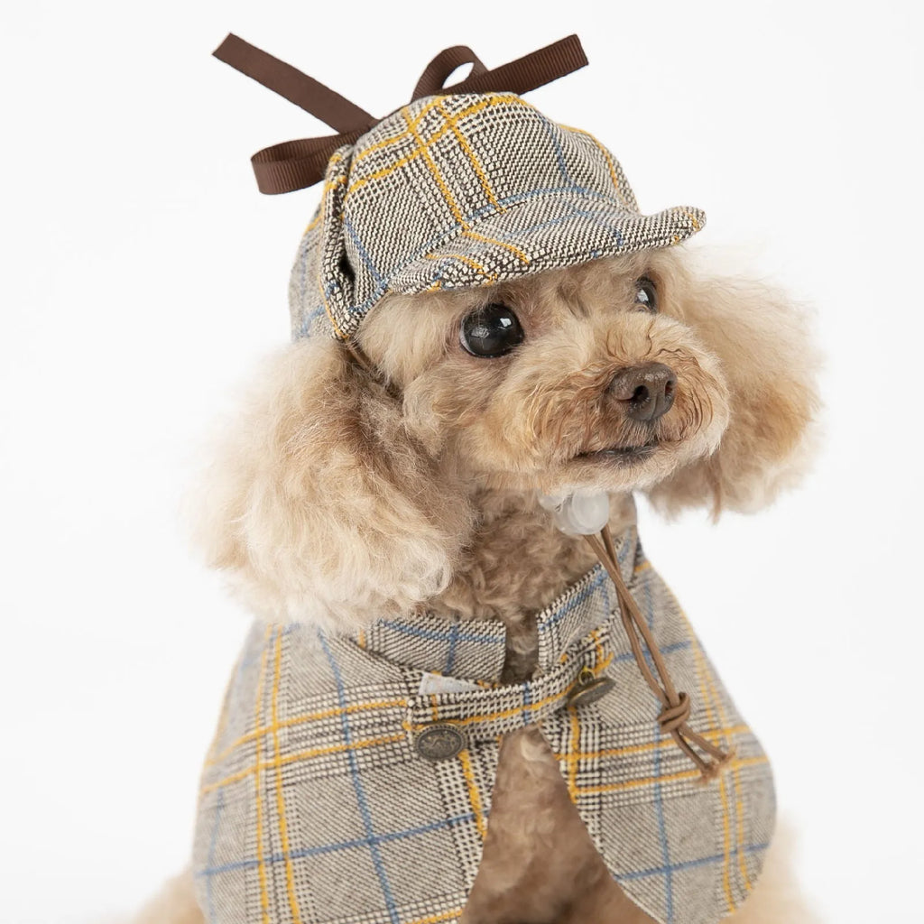 Camel-coloured detective-style cotton cloak for a small dog on a harness, showing the adjustable hat.