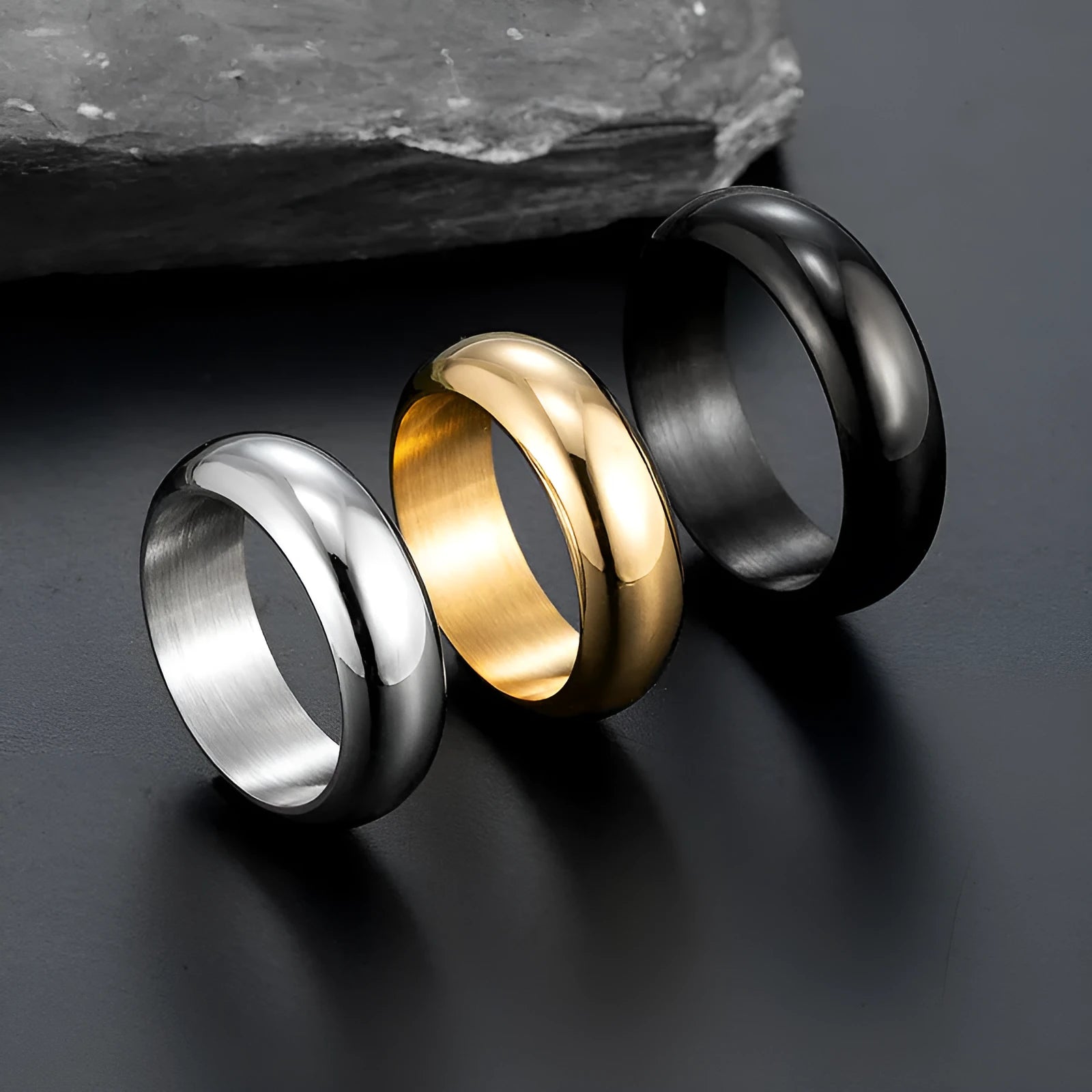 Glossy electroplated titanium steel ring shown in gold, black, and steel colour on a size chart from 7 to 12.