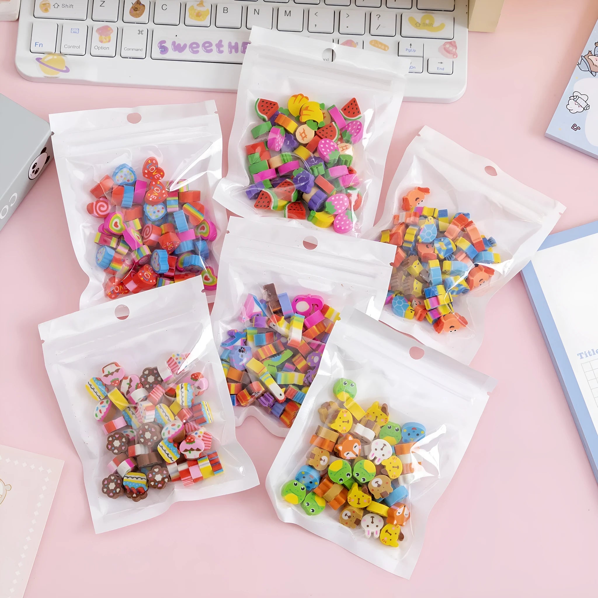 50 small colourful cartoon novelty erasers including fruit and animal shapes in a pearlescent film bag.