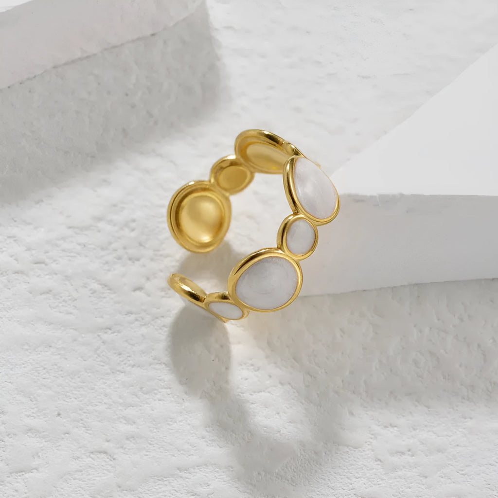 Silver geometric ring with adjustable opening on stainless steel background
