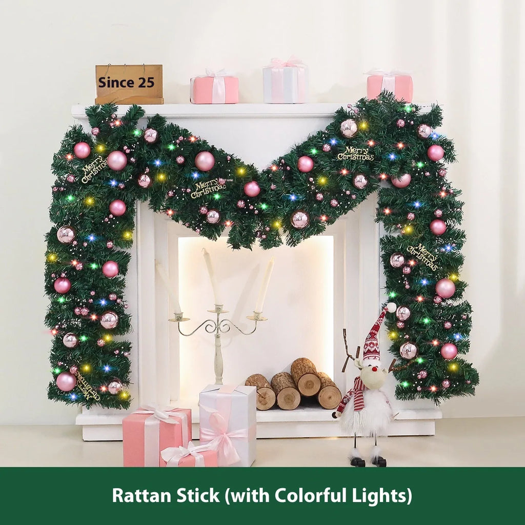 A long, pink artificial rattan Christmas garland with small fruits and leaves, shown draped decoratively.