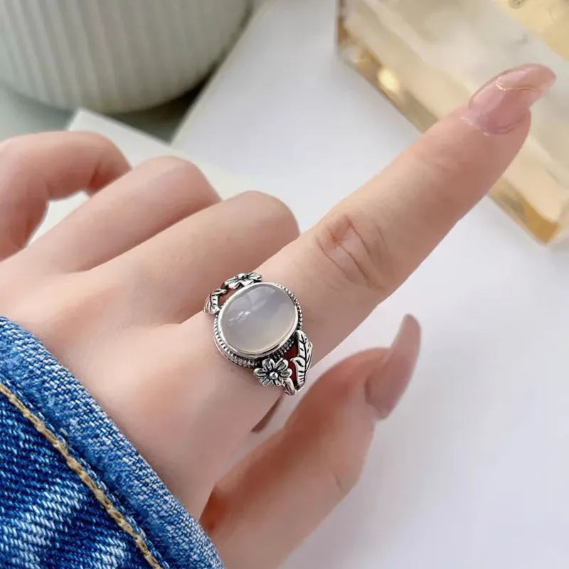 Copper vintage ring with imitation white chalcedony stone and adjustable U-shaped open design.