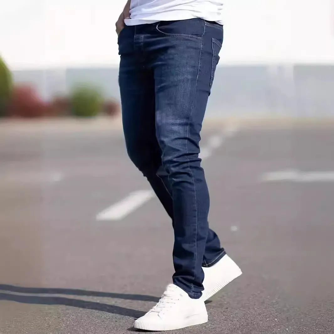 Dark blue men's slim fit casual jeans with a tight leg style and mid waist design.
