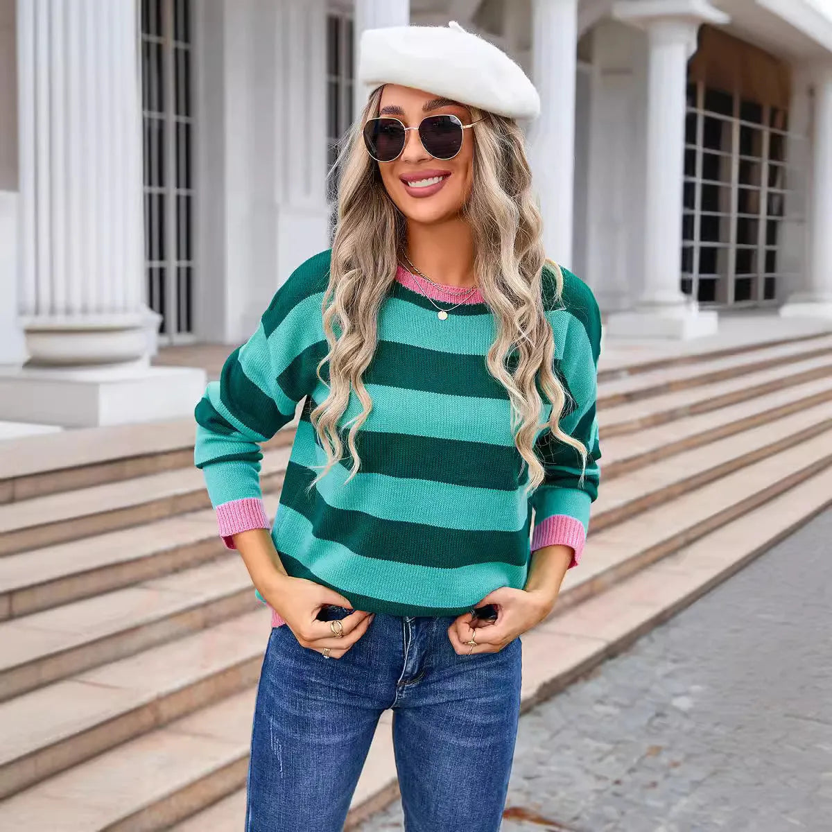 Women's loose blue striped acrylic long sleeve round neck sweater on a hanger