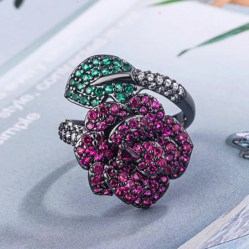 Geometric black gold women's ring with simulated red corundum stone and flower design elements