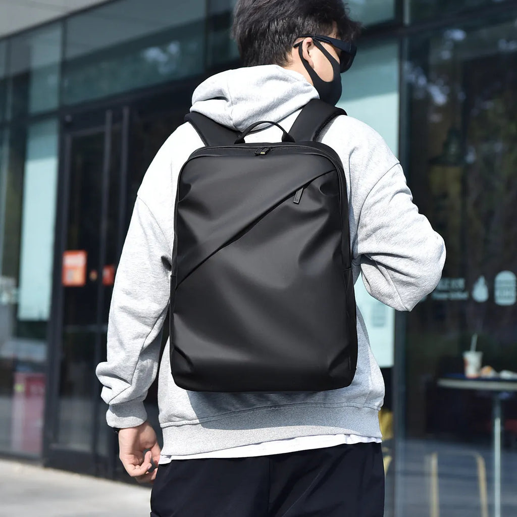 Waterproof PU leather men's backpack in black, blue and grey colour options showing large capacity design