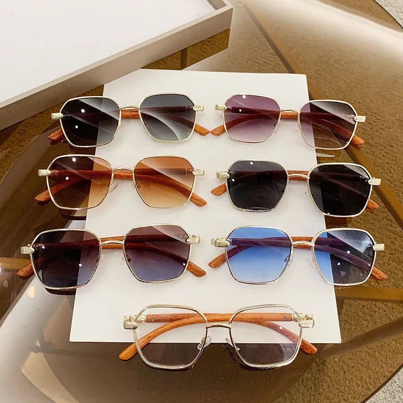 Women's gold alloy frame glasses with wood grain pattern and multiple coloured interchangeable lenses.