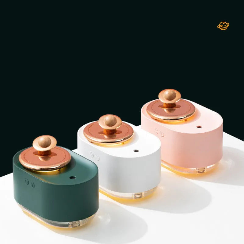 Green rotating planet-shaped USB humidifier with night light on a desk.