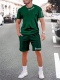 Men's navy blue printed short-sleeved top and matching shorts sports set on a white background