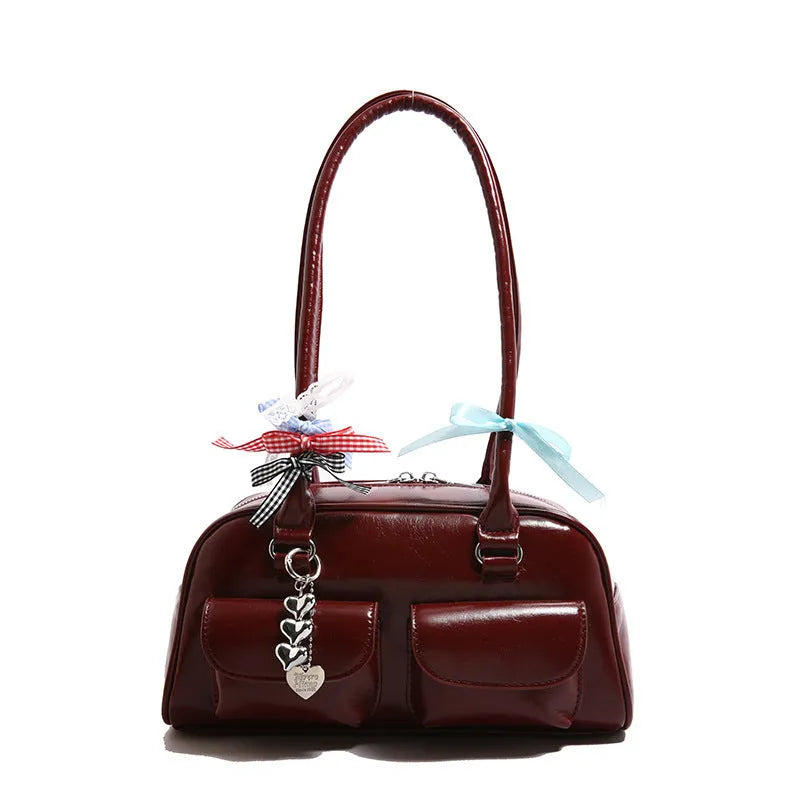 Retro brown PU leather women's pillow bag with double shoulder straps and a flap top closure.