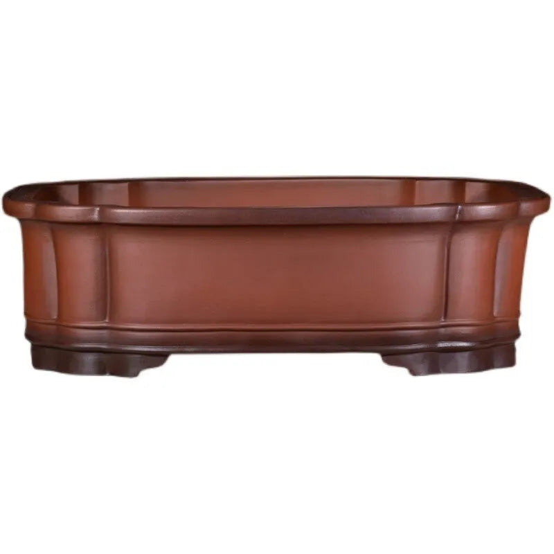 Antique-style purple clay flowerpot with Chinese decorative motifs showing tree stump, pine, cypress, pomegranate, golden marble, antique jade belt, and crabapple designs