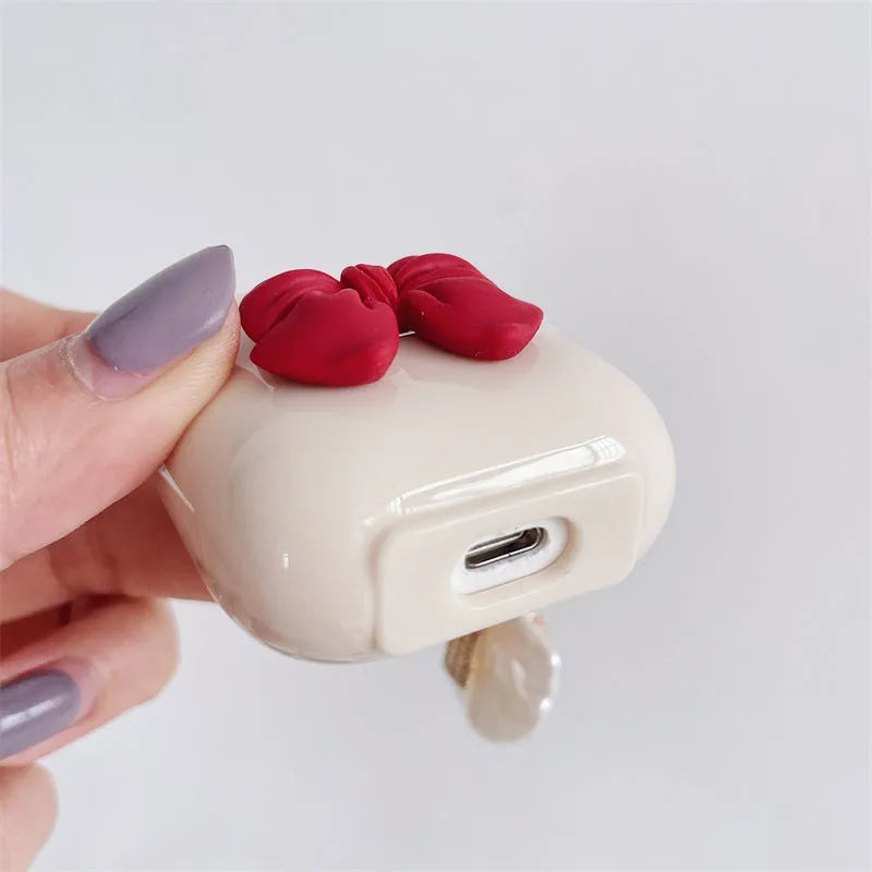 Beige red bow shell patterned TPU protective case for Apple AirPods Pro and AirPods 1, 2, 3 wireless earphones.