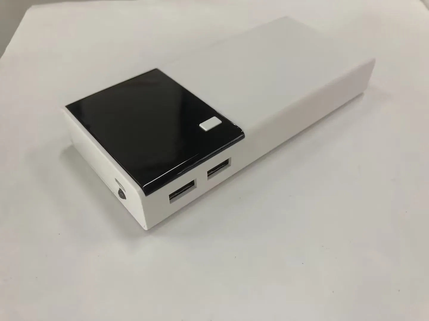 Black 20000mAh portable power bank with charging cable, dimensions 135mm by 60mm.