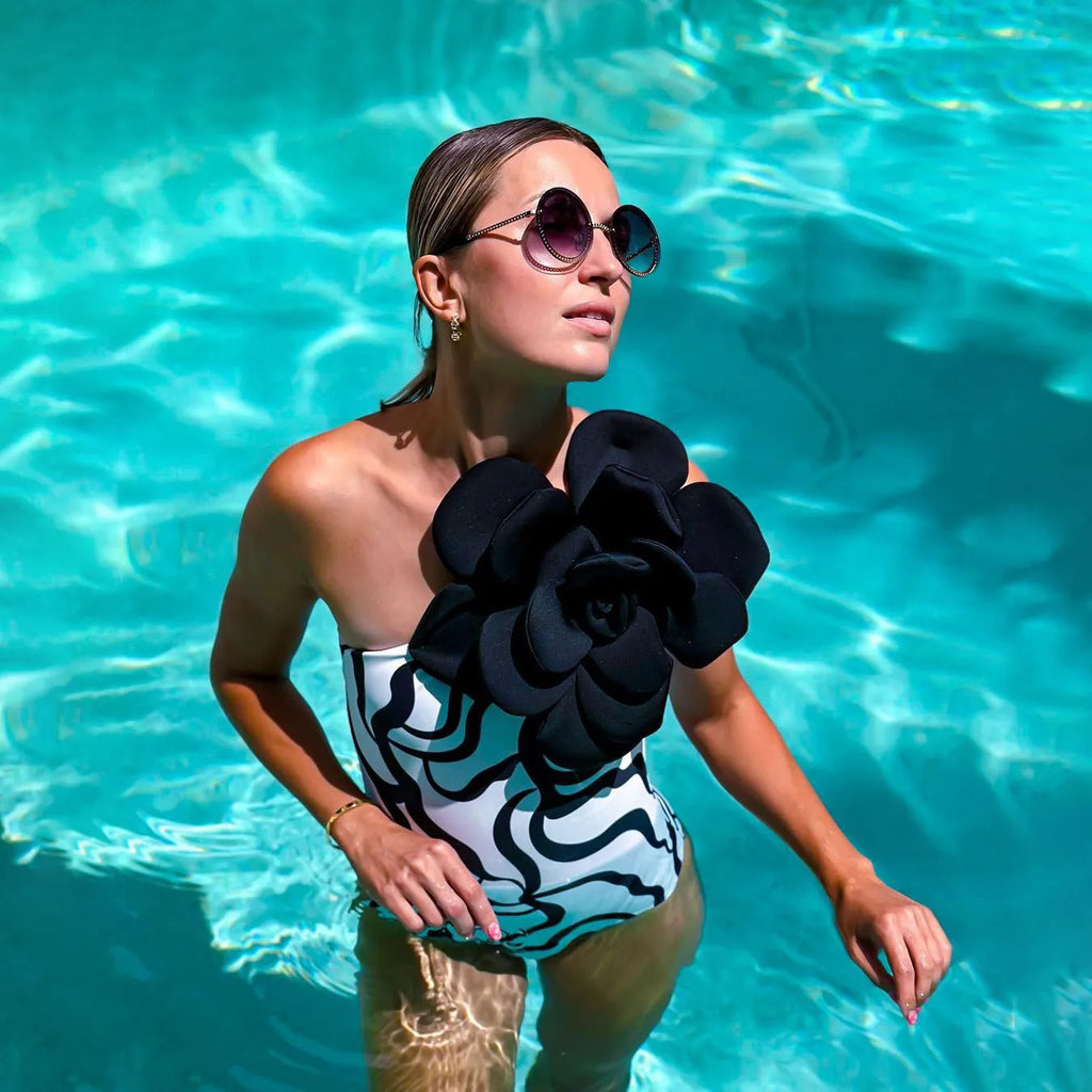 One-piece European American style swimsuit with three-dimensional floral patterns on solid colour background
