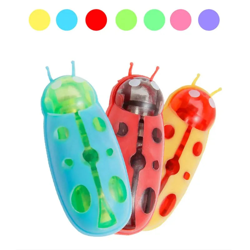 Mini electric bug cat toy in ladybug style with red body, PVC construction, crawling on a wooden floor