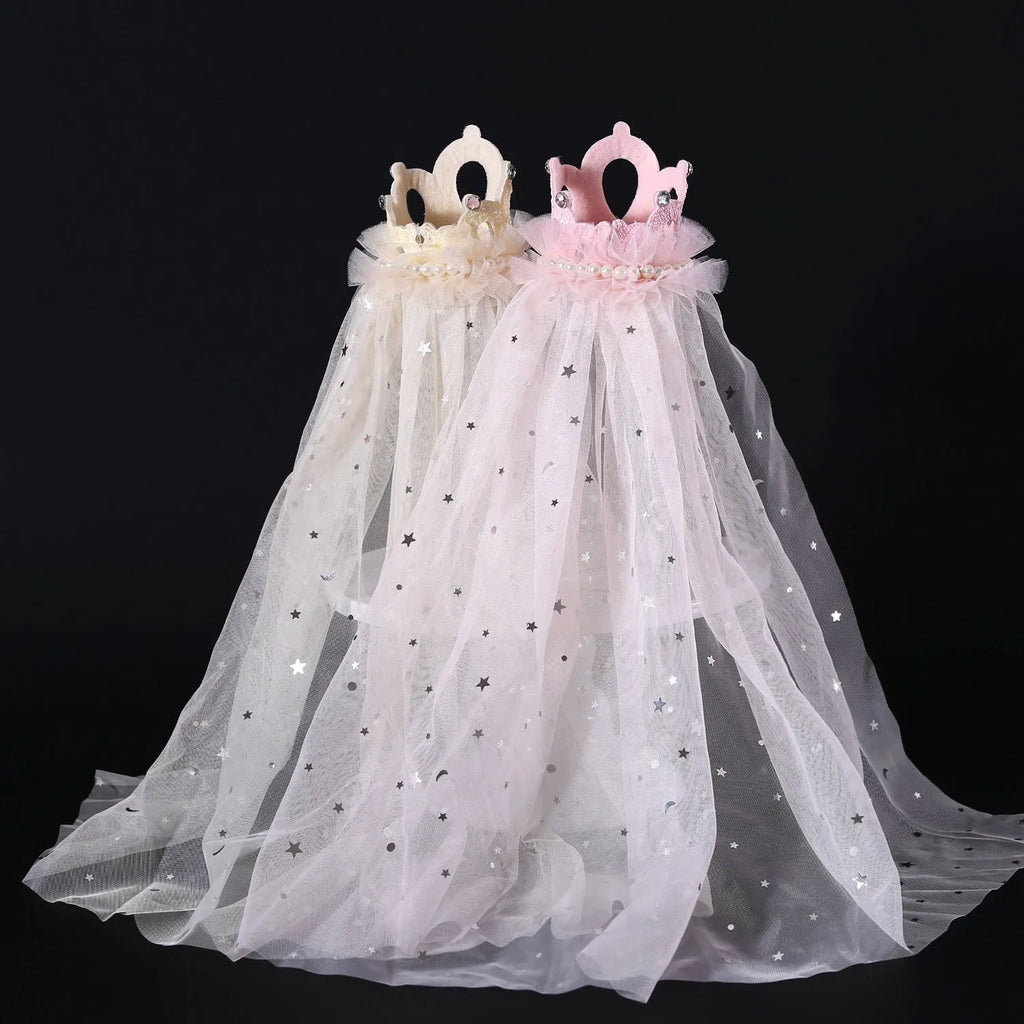 A beige and a pink princess crown headdress for cats on a white background.