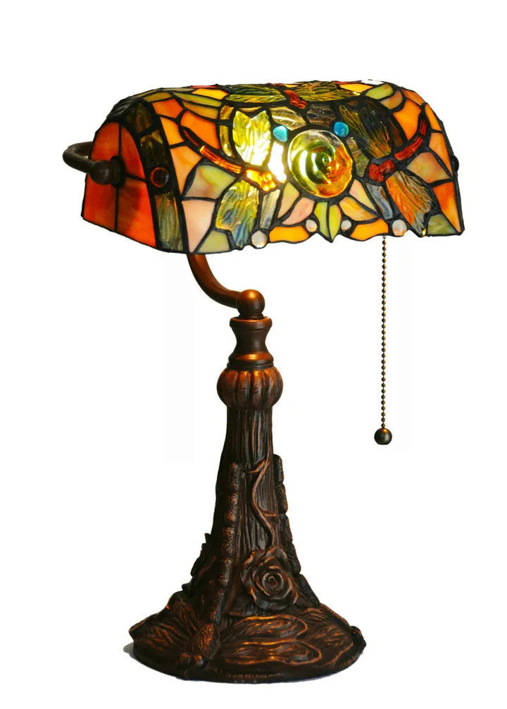10-inch Tiffany table lamp with coloured glass shade and resin base on a desk.