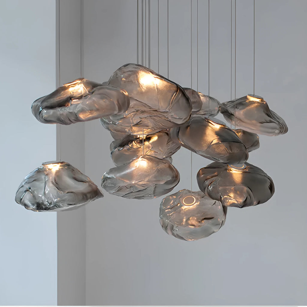 Modern decorative chandelier with glass shade and fabric design, available in amber, clear, or smoke grey.