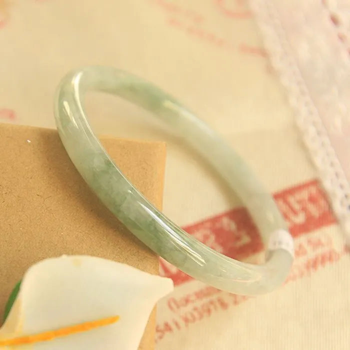 Green waxy jade geometric bracelet on a flat surface, 10mm bead thickness, handcrafted Chinese style