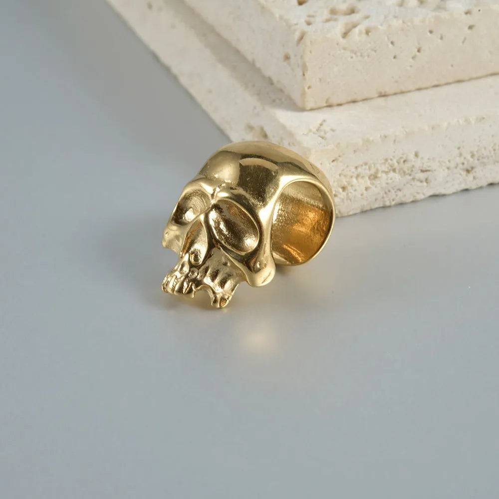 Stainless steel hollow skull Buddha earrings showing four electroplated colour options