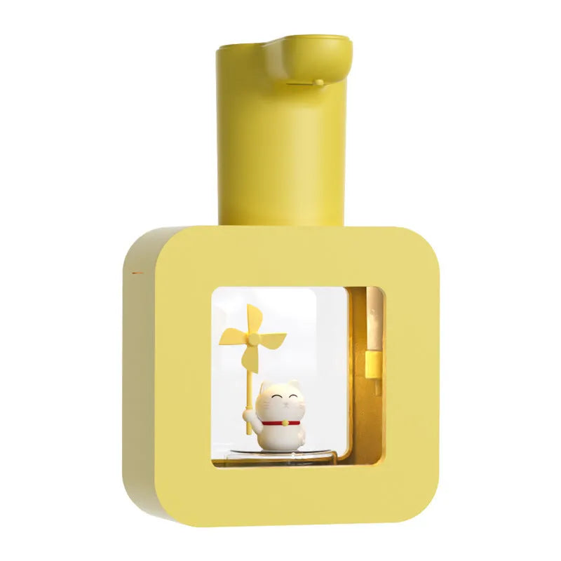 Pink automatic soap dispenser for kids with cartoon unicorn and kitten design on a bathroom counter.