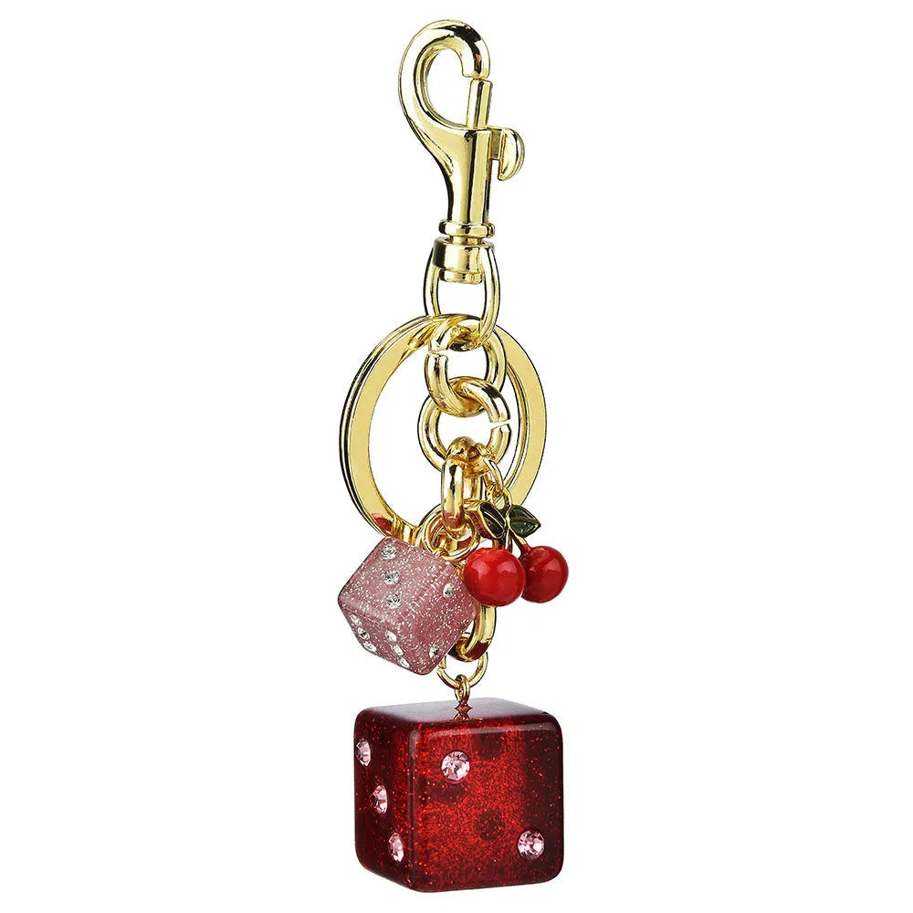 Square metal keychain pendant with a vintage red and white cherry dice pattern.
