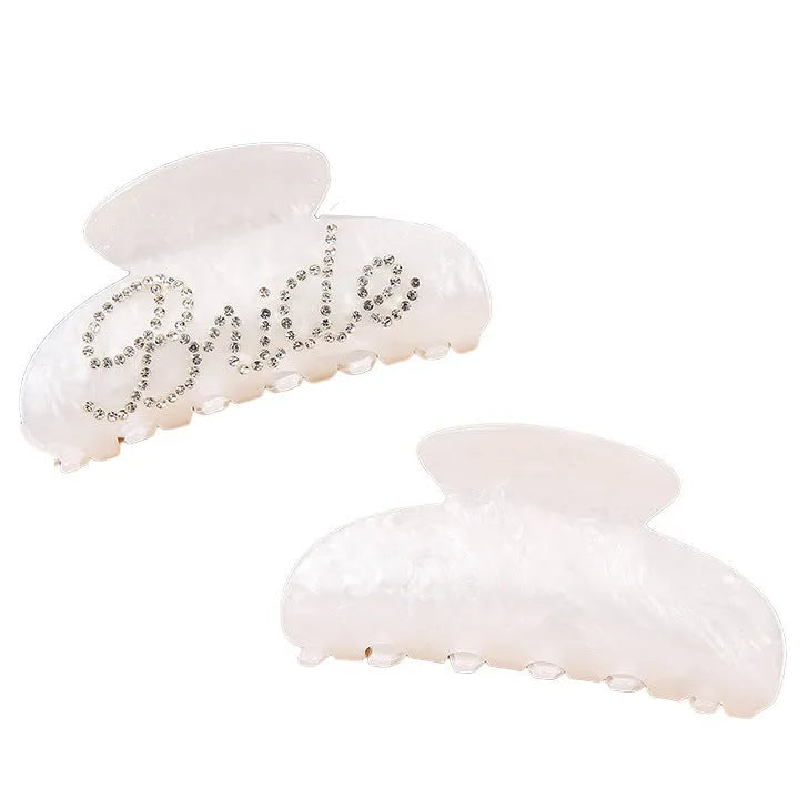 Acrylic hair barrette with diamond pattern and English letters measuring 10cm wide in pink colour
