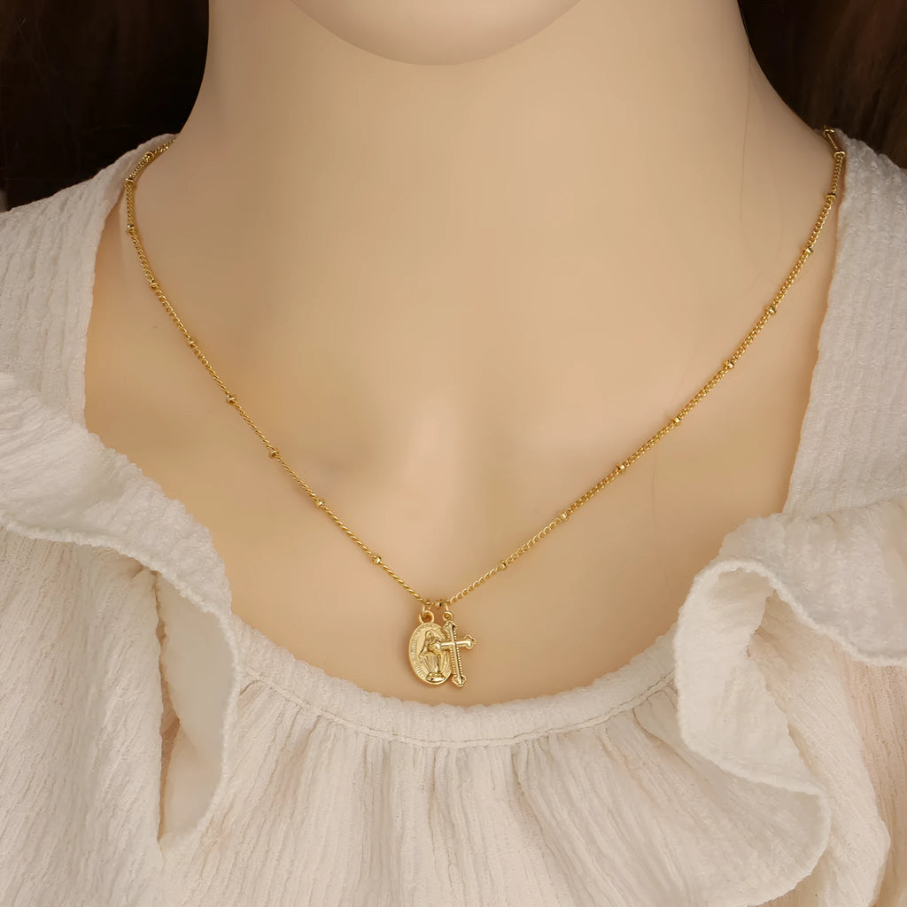 Virgin Mary geometric cross necklace in gold colour with 18k gold-plated copper construction