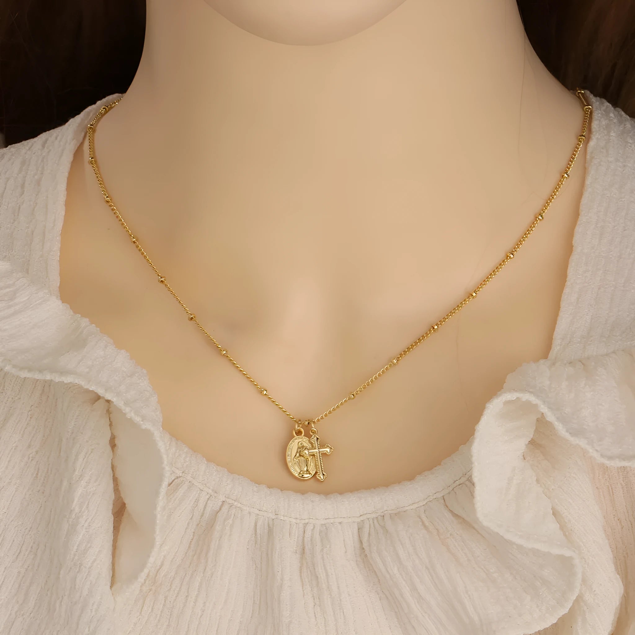 Virgin Mary geometric cross necklace in gold colour with 18k gold-plated copper construction