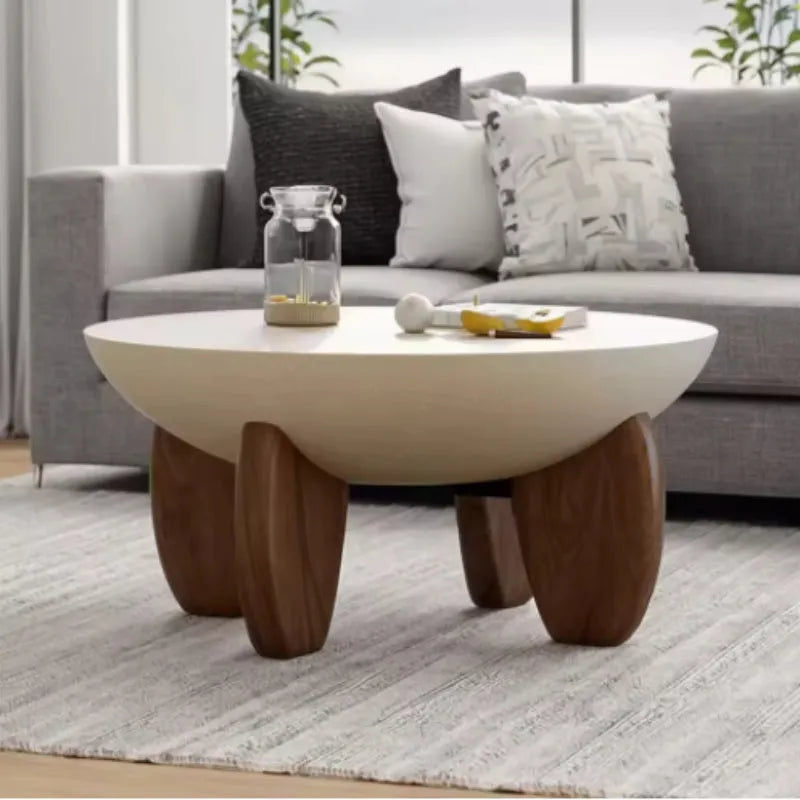 White adjustable height solid wood coffee table shown in a living room setting.