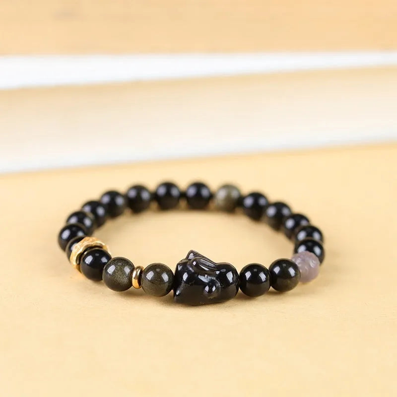 Handmade national style bracelet with lying rabbit Jin Yaoshi charm on neutral background, 8mm beads