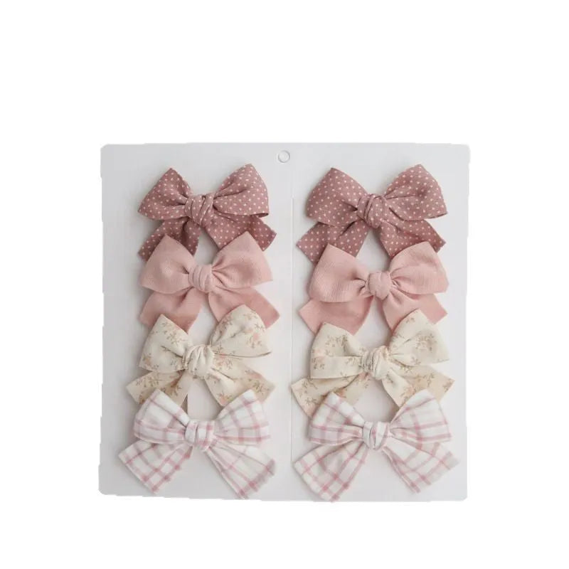 Children's cloth bow hairclips in eight-piece set with dovetail design