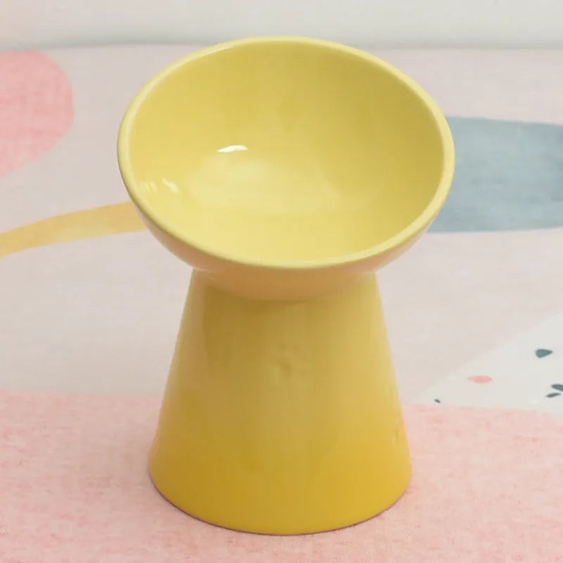 Ceramic anti-tumble pet bowl for dogs and cats with high foot and neck protector.