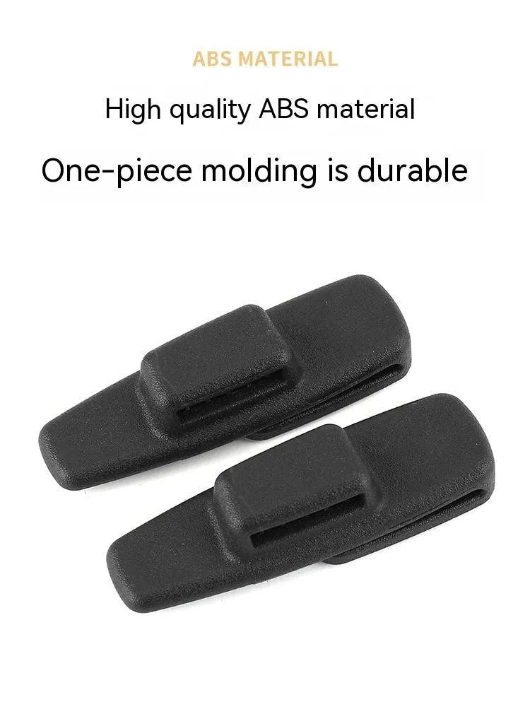 Two black ABS car safety belt stopper universal clips for seat belt adjustment, supplied in OPP bag