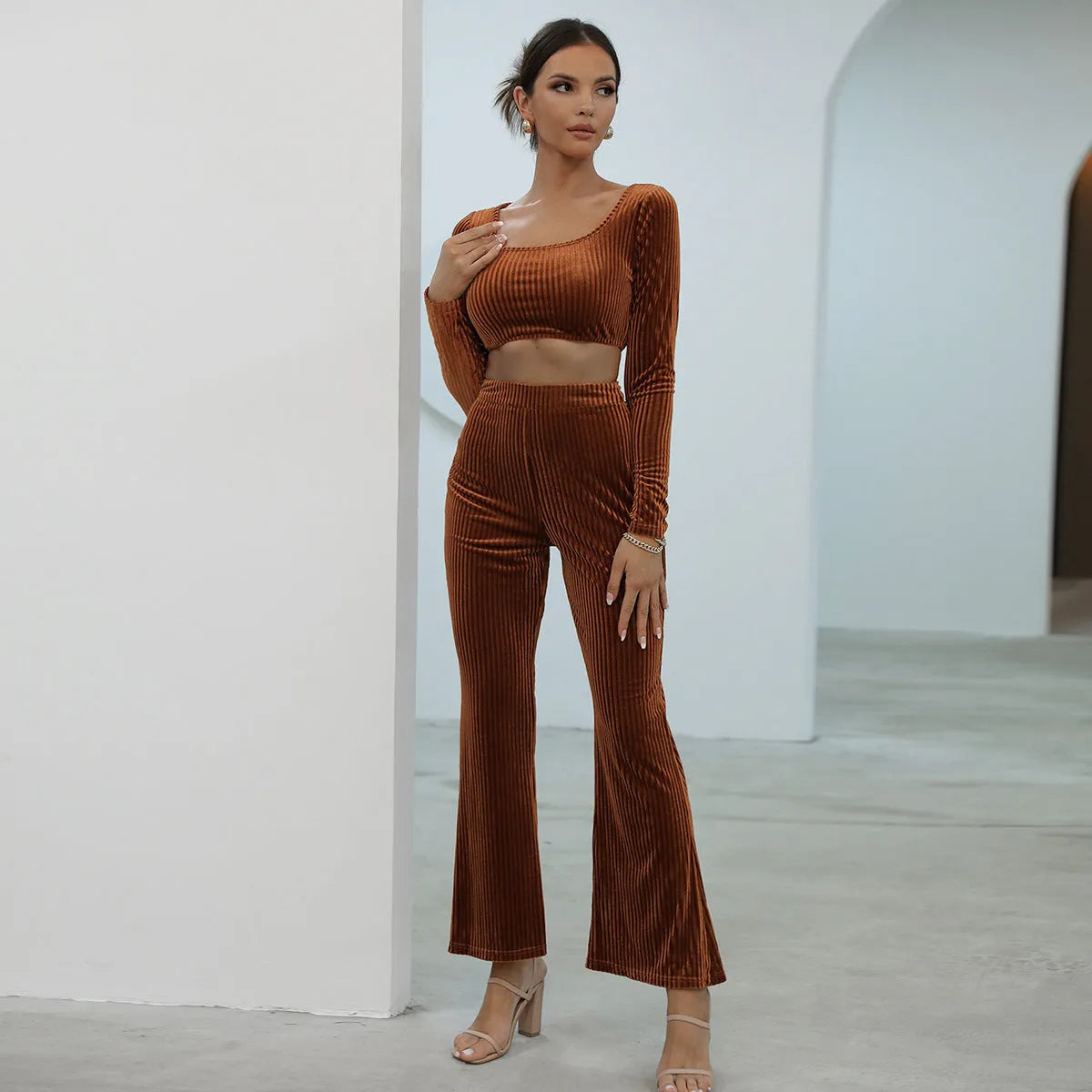 Caramel coloured long sleeve sweater and trousers casual set on a hanger.