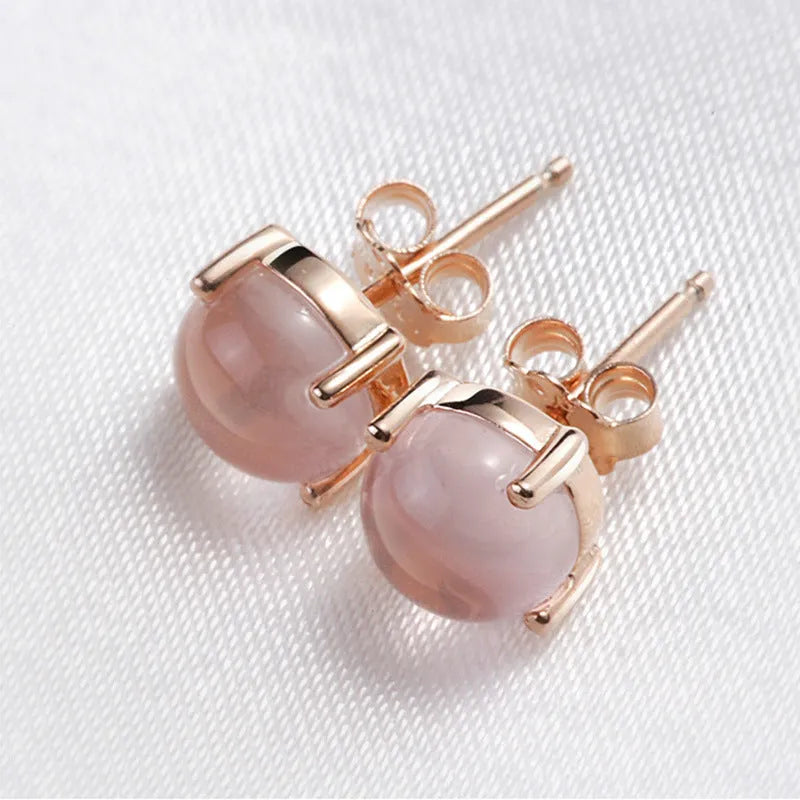 Rose gold coloured drop shaped stud earrings for women with a synthetic quartz stone.