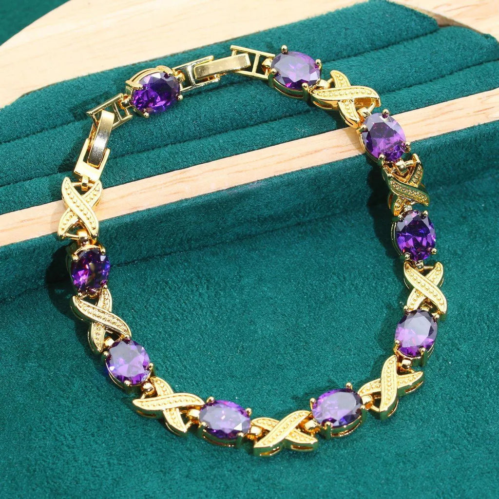 18k gold plated jewellery set with cubic zirconia stones, showing necklace, earrings, bracelet, and ring.